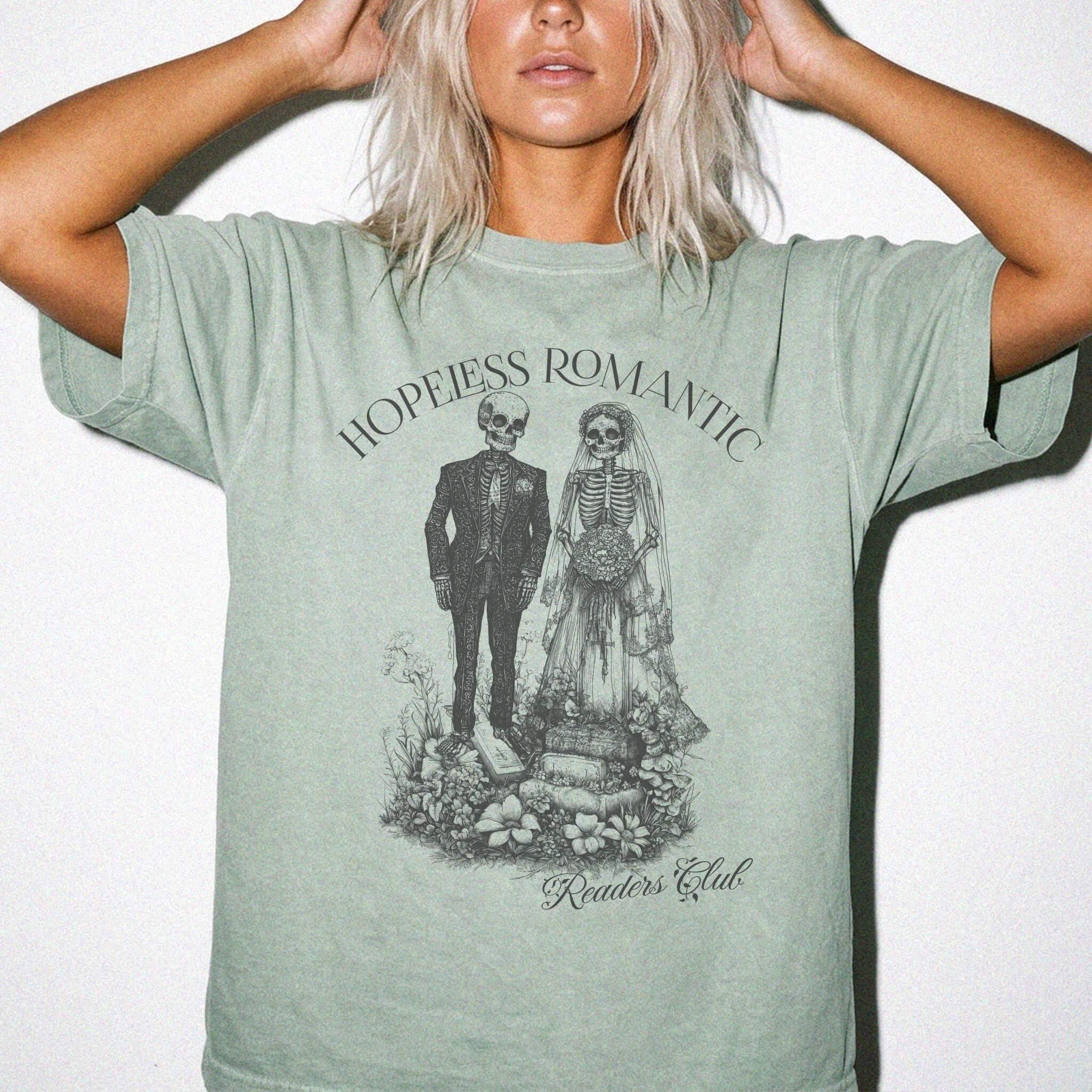 Hopeless Romantic Readers Club Tee in Bay – vintage-style Comfort Colors graphic tee for dark romance readers. Graphic features a skeleton couple on their wedding day.