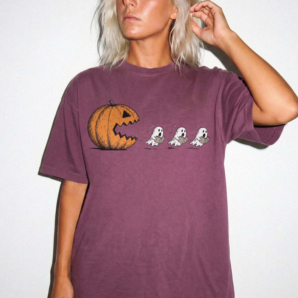 Berry Comfort Colors 1717 relaxed fit tee with pumpkin chasing book ghosts Halloween bookish graphic — front