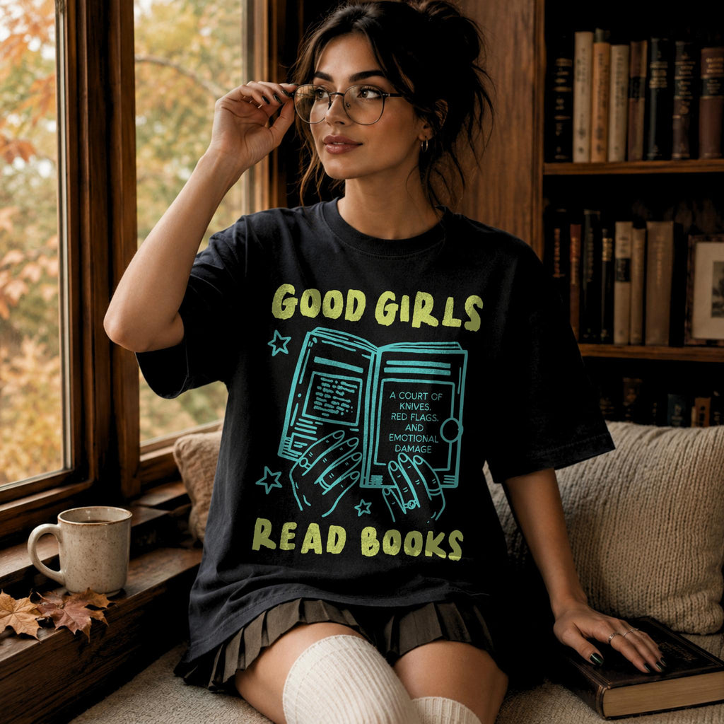 Black color Comfort Colors 1717 relaxed fit t-shirt with Y2K retro doodle graphic — hands holding an open book titled "A Court of Knives, Red Flags, and Emotional Damage" with the text "Good Girls Read Books" above and below
