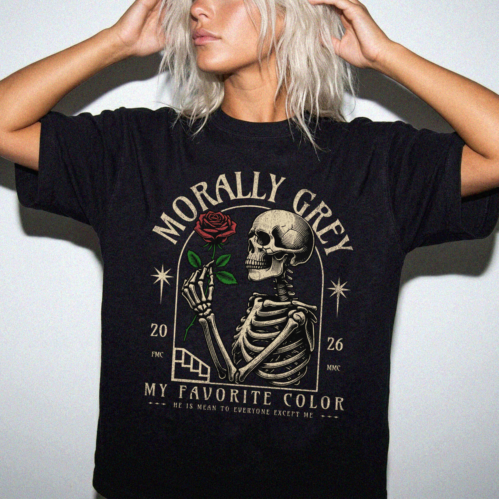 Black color Comfort Colors 1717 relaxed fit t-shirt with dark romance graphic — a skeleton holding a red rose beneath an arch with the text "Morally Grey — My Favorite Color" and the tagline "He is mean to everyone except me"