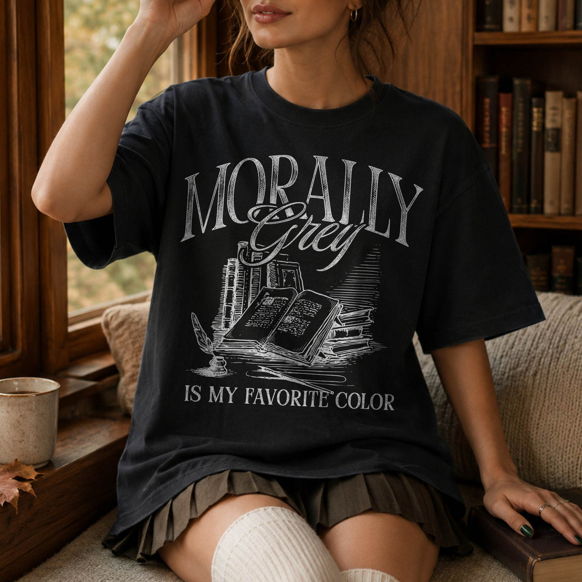 Morally Grey Is My Favorite Color dark academia design on a black color tee from Comfort Colors with vintage stacked books and quill graphic.