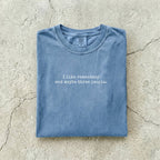 Blue Jean Comfort Colors tee folded flat reading "I like romantasy and maybe three people." in a typewriter font.