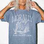Morally Grey Is My Favorite Color dark academia design on a blue jean color tee from Comfort Colors with vintage stacked books and quill graphic.