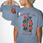 Comfort Colors 1717 Blue Jean relaxed fit tee with painterly red rose pocket print on front and ornate sword wrapped in roses with red gothic text 'Through Thorns + Ashes We Will Bloom' on back
