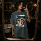 Blue Spruce Comfort Colors 1717 relaxed fit t-shirt with retro pop art graphic — a woman with teal hair and sunglasses reflecting a couple, a single tear on her cheek, with the word BE·TRAY·AL (betrayal) and the tagline "she loves a plot twist, but not this kind" 
