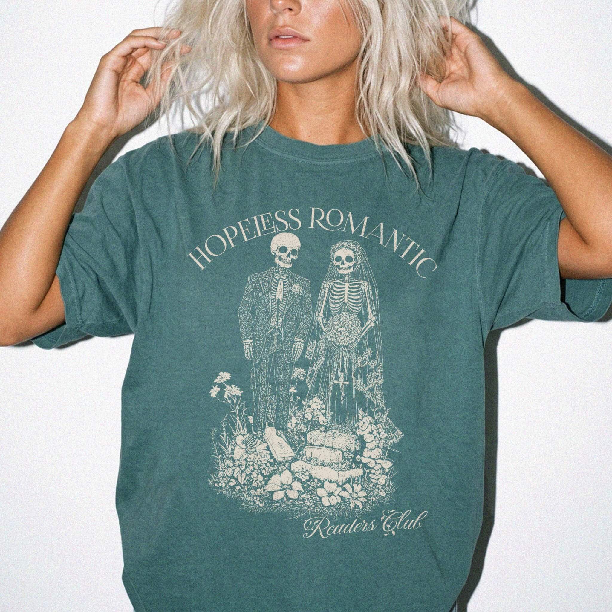 Hopeless Romantic Readers Club Tee in Blue Spruce – vintage-style Comfort Colors graphic tee for dark romance readers. Graphic features a skeleton couple on their wedding day.