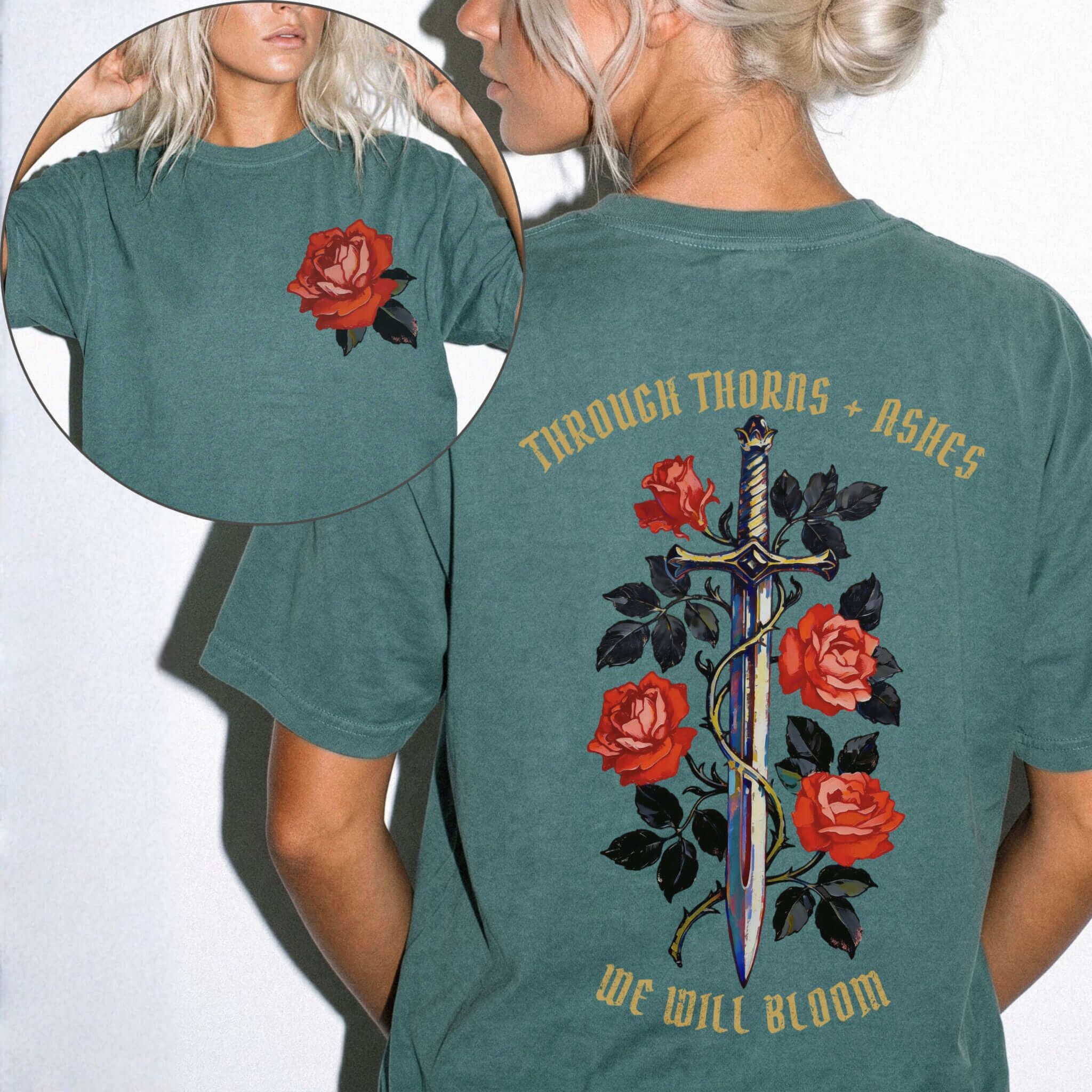 Comfort Colors 1717 Blue Spruce relaxed fit tee with painterly red rose pocket print on front and ornate sword wrapped in roses with gold gothic text 'Through Thorns + Ashes We Will Bloom' on back