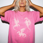 Crunchberry color Comfort Colors 1717 relaxed fit t-shirt with whimsigoth fantasy graphic — three detailed dragon illustrations surrounded by stars and celestial details in off-white line art