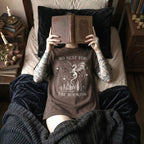 Espresso color Comfort Colors 1717 relaxed fit t-shirt with gothic romantasy graphic — two dragons soaring over a castle beneath moons and celestial details, with the text "No Rest for the Bookish"
