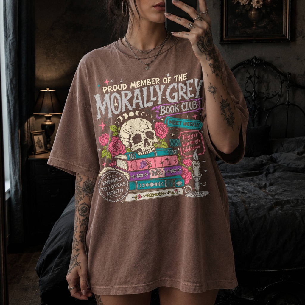 Morally Grey Book Club dark romance bookish tee in Espresso color by Comfort Colors, featuring skull, roses, and stacked books graphic with enemies to lovers and trigger warnings text.