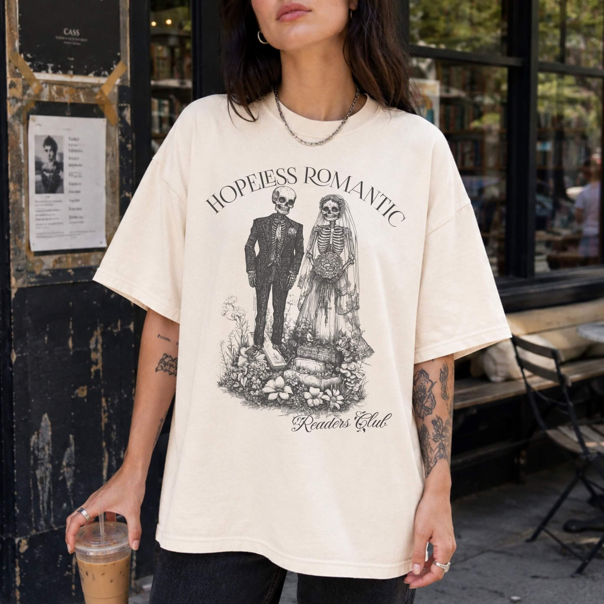 Hopeless Romantic Readers Club Tee in Ivory – vintage-style Comfort Colors graphic tee for dark romance readers. Graphic features a skeleton couple on their wedding day.
