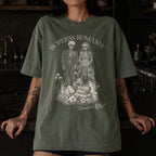 Hopeless Romantic Readers Club Tee in Moss – vintage-style Comfort Colors graphic tee for dark romance readers. Graphic features a skeleton couple on their wedding day.