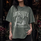 Morally Grey Is My Favorite Color dark academia design on a moss color tee from Comfort Colors with vintage stacked books and quill graphic.