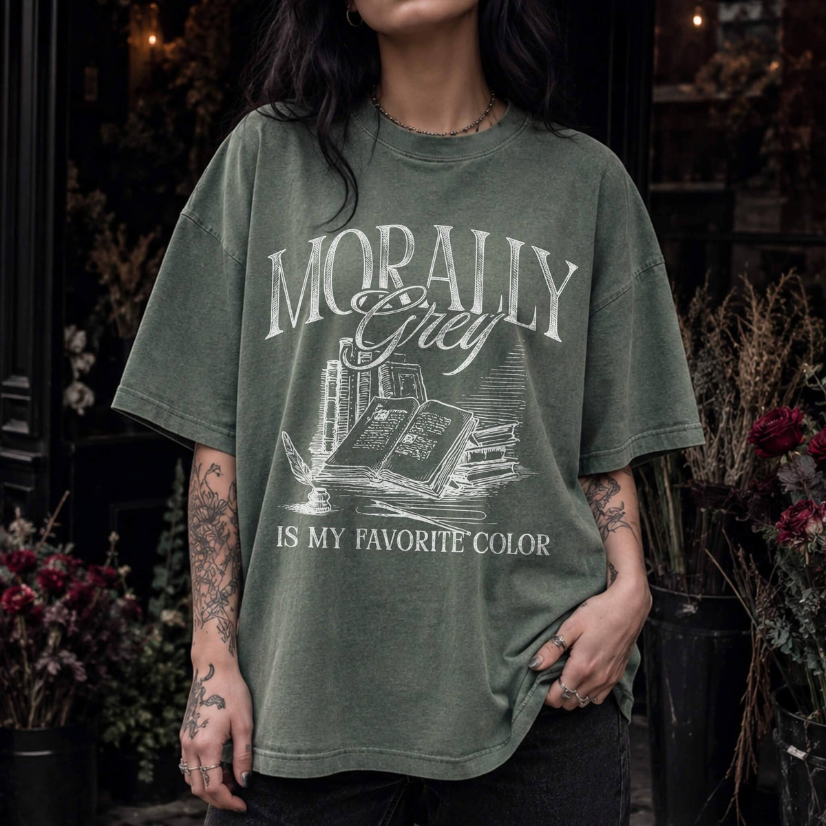 Morally Grey Is My Favorite Color dark academia design on a moss color tee from Comfort Colors with vintage stacked books and quill graphic.