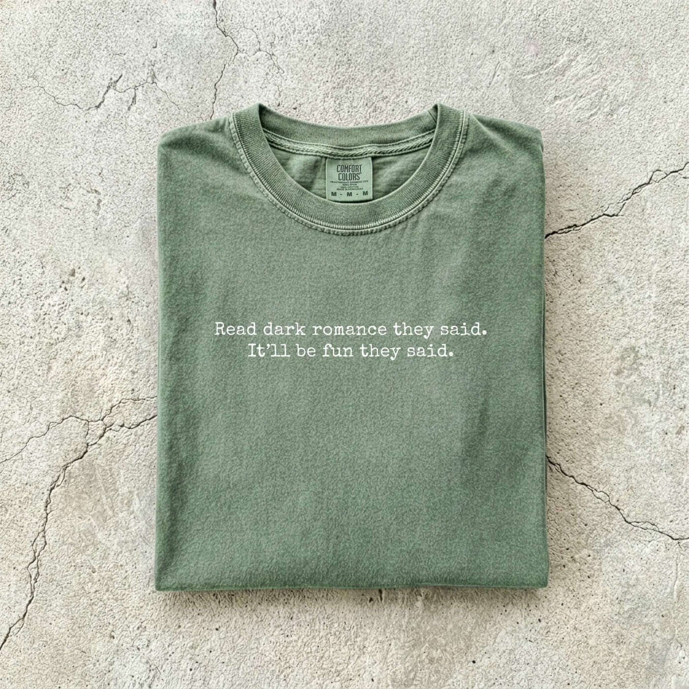 Moss Comfort Colors tee folded flat reading "Read dark romance they said. It'll be fun they said." in a minimal typewriter font.