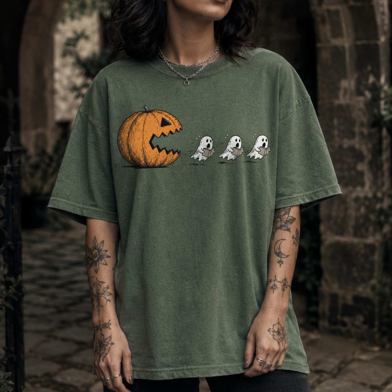 Moss Comfort Colors 1717 relaxed fit tee with pumpkin chasing book ghosts Halloween bookish graphic — front