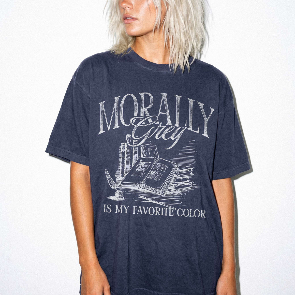 Morally Grey Is My Favorite Color dark academia design on a navy color tee from Comfort Colors with vintage stacked books and quill graphic.