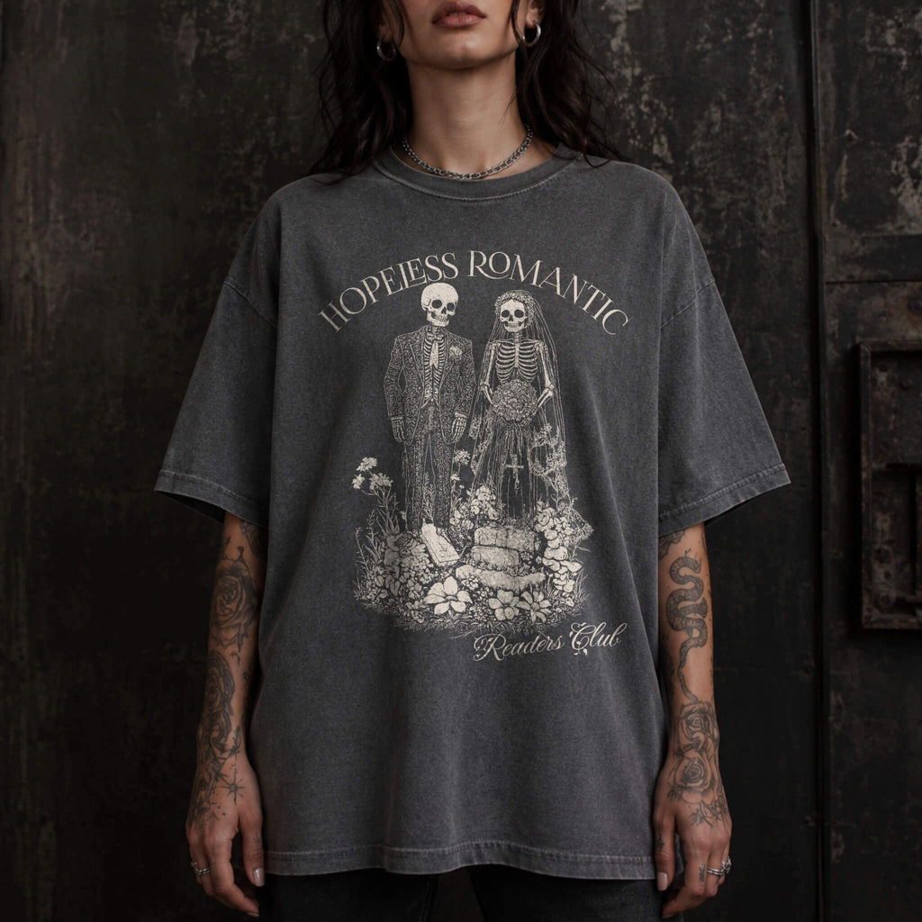 Hopeless Romantic Readers Club Tee in Pepper – vintage-style Comfort Colors graphic tee for dark romance readers. Graphic features a skeleton couple on their wedding day.
