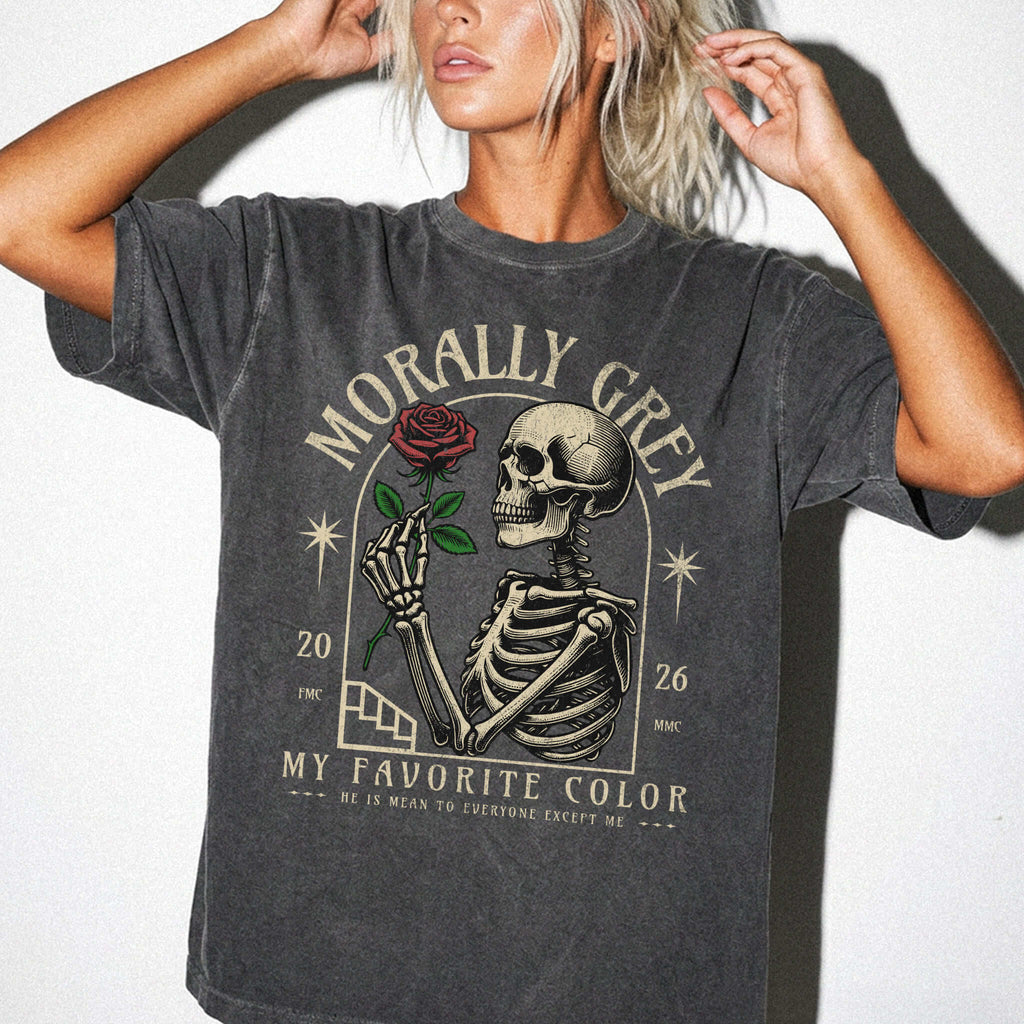 Pepper color Comfort Colors 1717 relaxed fit t-shirt with dark romance graphic — a skeleton holding a red rose beneath an arch with the text "Morally Grey — My Favorite Color" and the tagline "He is mean to everyone except me"