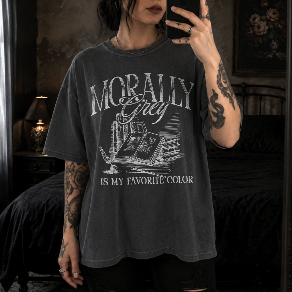 Morally Grey Is My Favorite Color dark academia design on a pepper color tee from Comfort Colors with vintage stacked books and quill graphic.