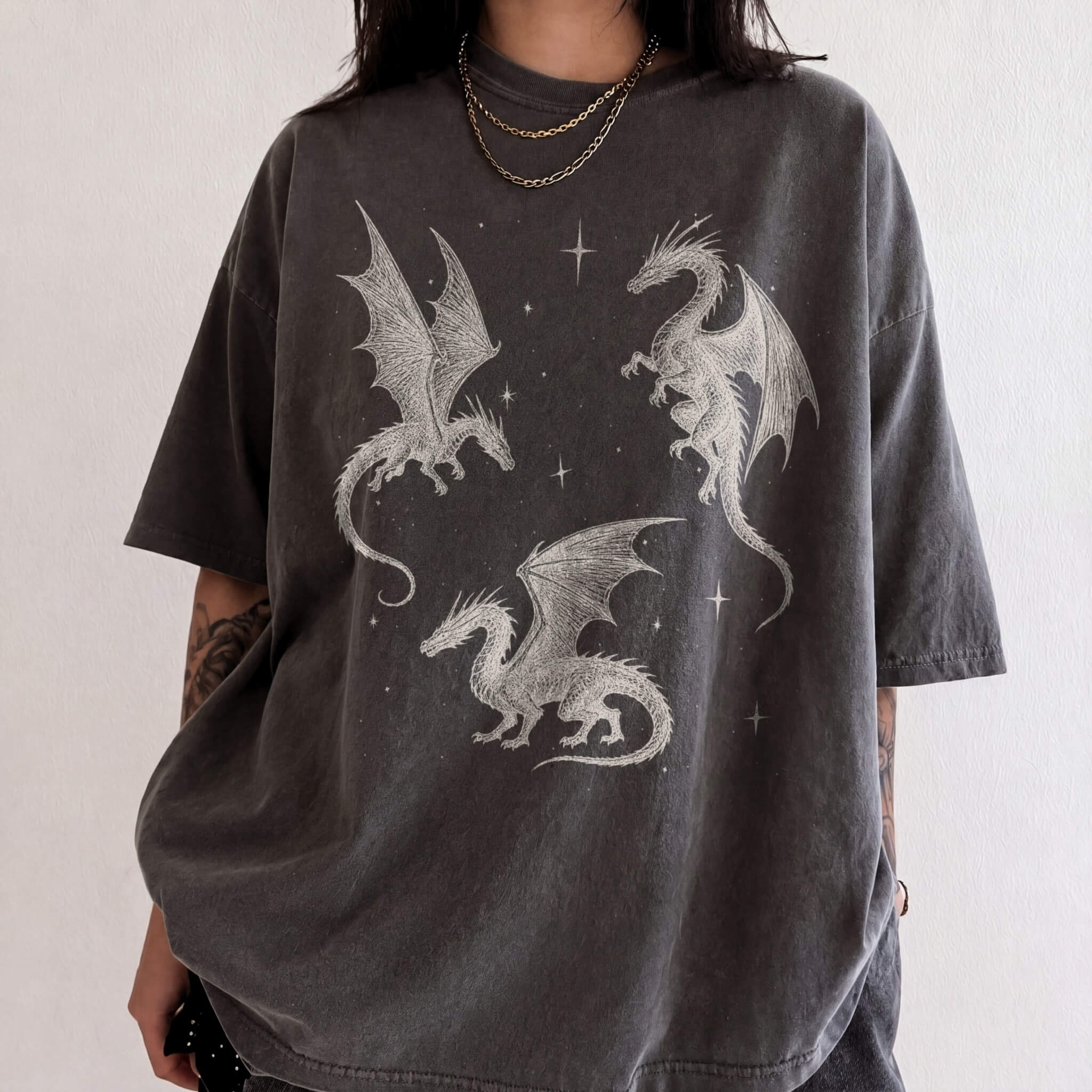 Pepper color Comfort Colors 1717 relaxed fit t-shirt with whimsigoth fantasy graphic — three detailed dragon illustrations surrounded by stars and celestial details in off-white line art