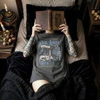 Pepper color Comfort Colors 1717 relaxed fit t-shirt with gothic dark romance graphic — a raven perched on a skull, a snake coiled on stacked books, a candle, and florals, with the text "Dark Romance Book Club — Enter for the Plot, Stay for the Trauma"