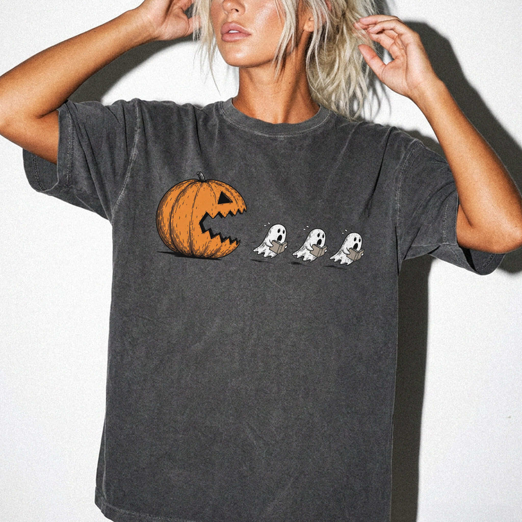 Pepper Comfort Colors 1717 relaxed fit tee with pumpkin chasing book ghosts Halloween bookish graphic — front