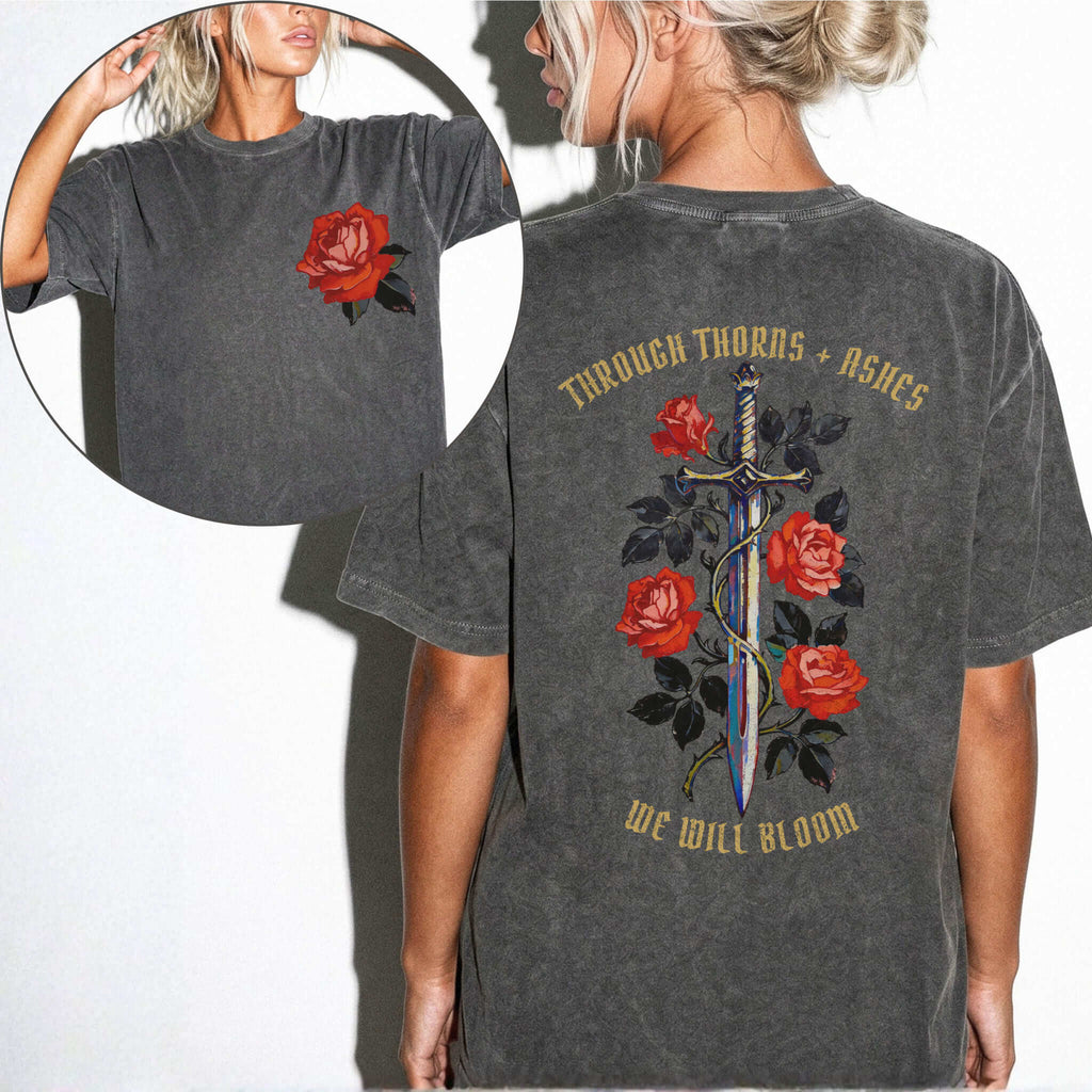 Comfort Colors 1717 Pepper relaxed fit tee with painterly red rose pocket print on front and ornate sword wrapped in roses with gold gothic text 'Through Thorns + Ashes We Will Bloom' on back