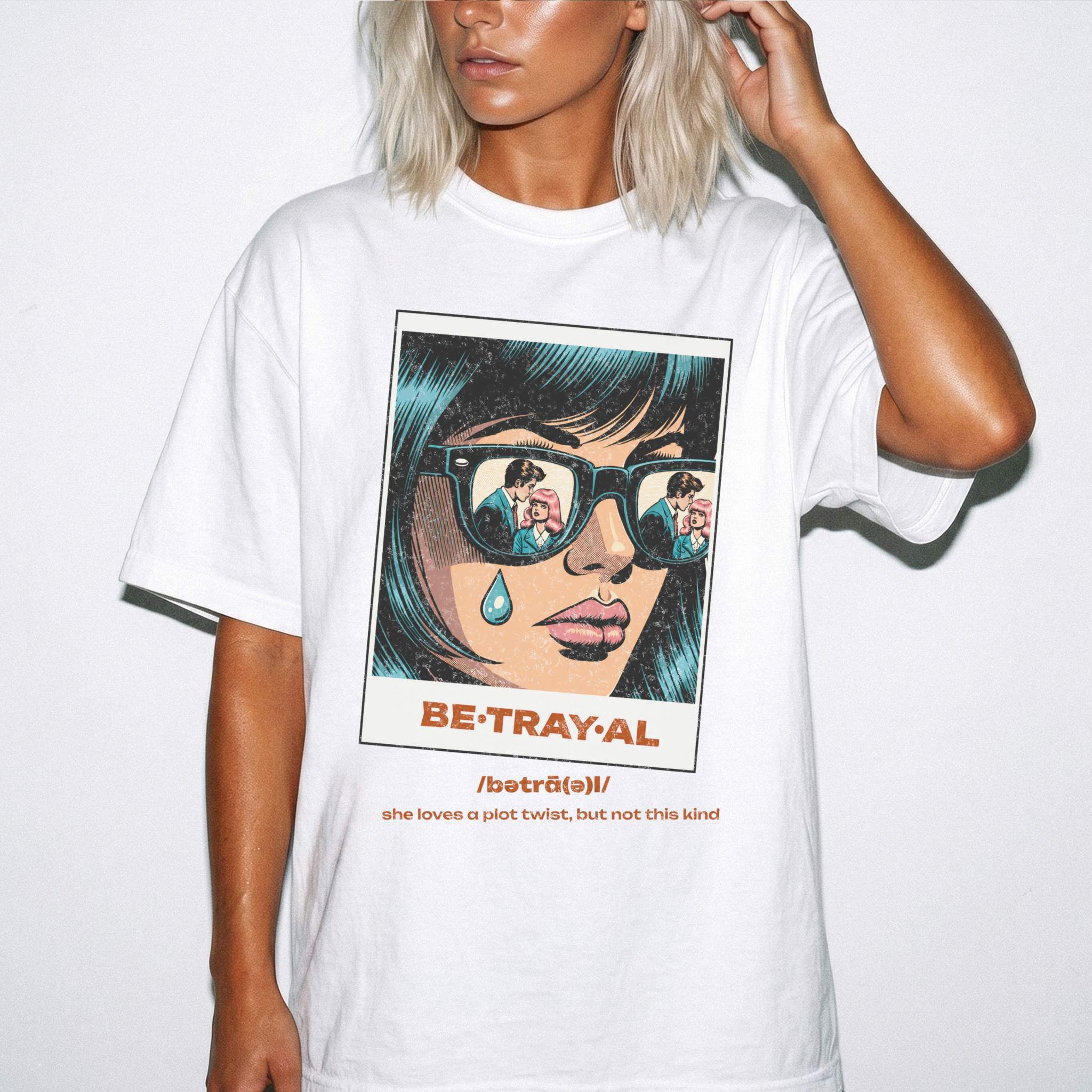 White Comfort Colors 1717 relaxed fit t-shirt with retro pop art graphic — a woman with teal hair and sunglasses reflecting a couple, a single tear on her cheek, with the word BE·TRAY·AL (betrayal) and the tagline "she loves a plot twist, but not this kind" 