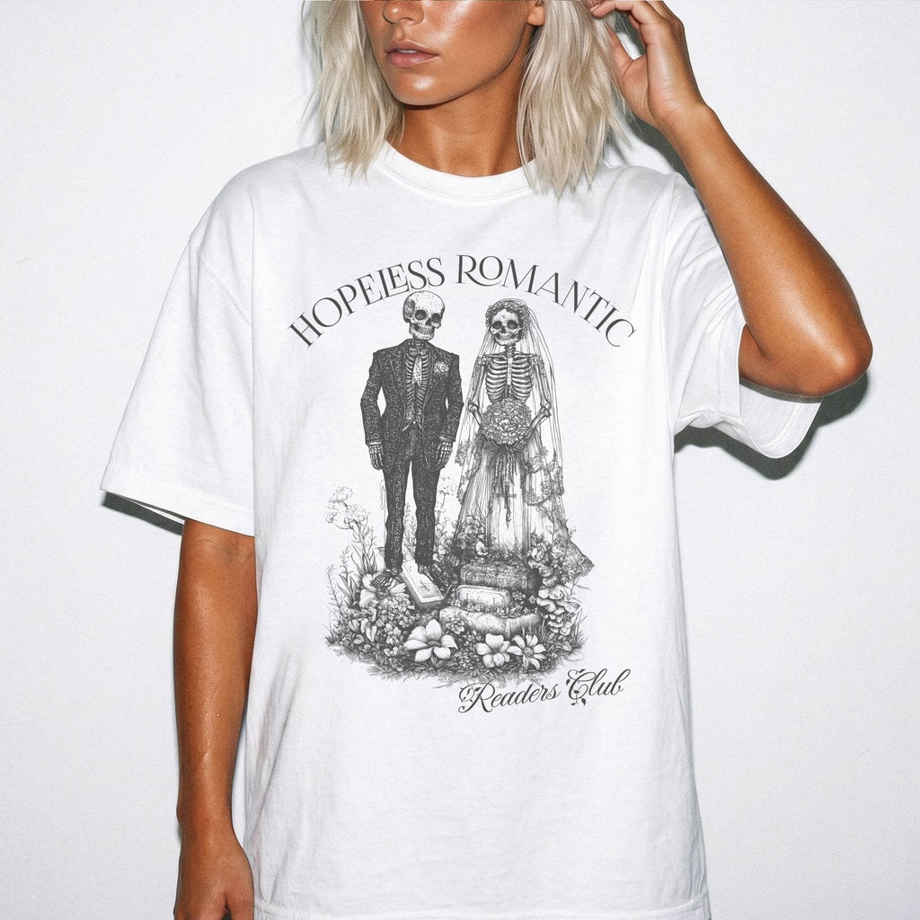 Hopeless Romantic Readers Club Tee in White – vintage-style Comfort Colors graphic tee for dark romance readers. Graphic features a skeleton couple on their wedding day.