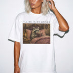 White Comfort Colors 1717 relaxed fit tee with oil painting style raccoon reading in elegant bedroom and I'll Be In My Office text