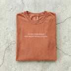 Yam Comfort Colors tee folded flat reading "I like romantasy and maybe three people." in a typewriter font.
