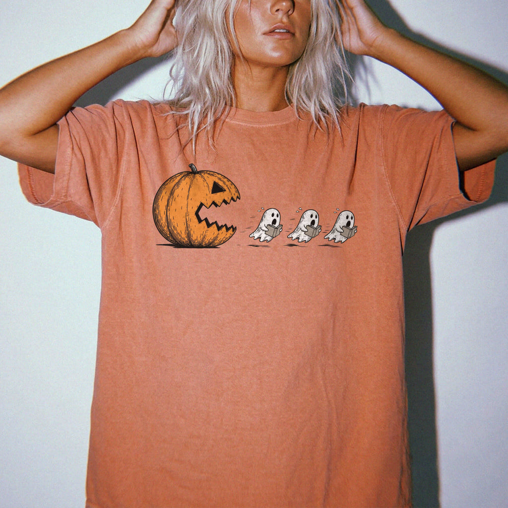 Yam Comfort Colors 1717 relaxed fit tee with pumpkin chasing book ghosts Halloween bookish graphic — front
